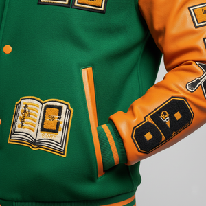 Green and orange varsity jacket with patches and a book design on a gray background 