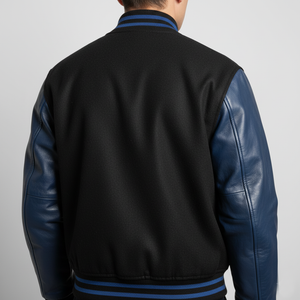 Black and blue varsity jacket on a gray background