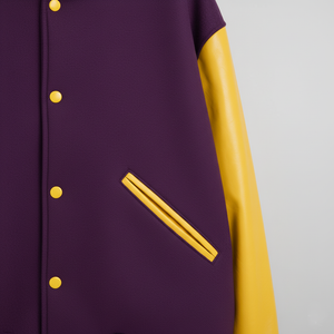 Purple and yellow jacket with buttons on a gray background