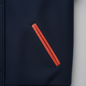Navy blue shirt with a red stripe on pocket on a light gray background
