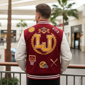 Person wearing a red letterman jacket with gold and white designs in an indoor setting