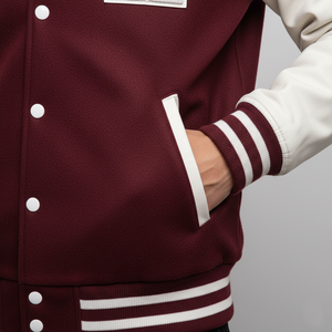 Maroon varsity jacket with white buttons and trim on a neutral background