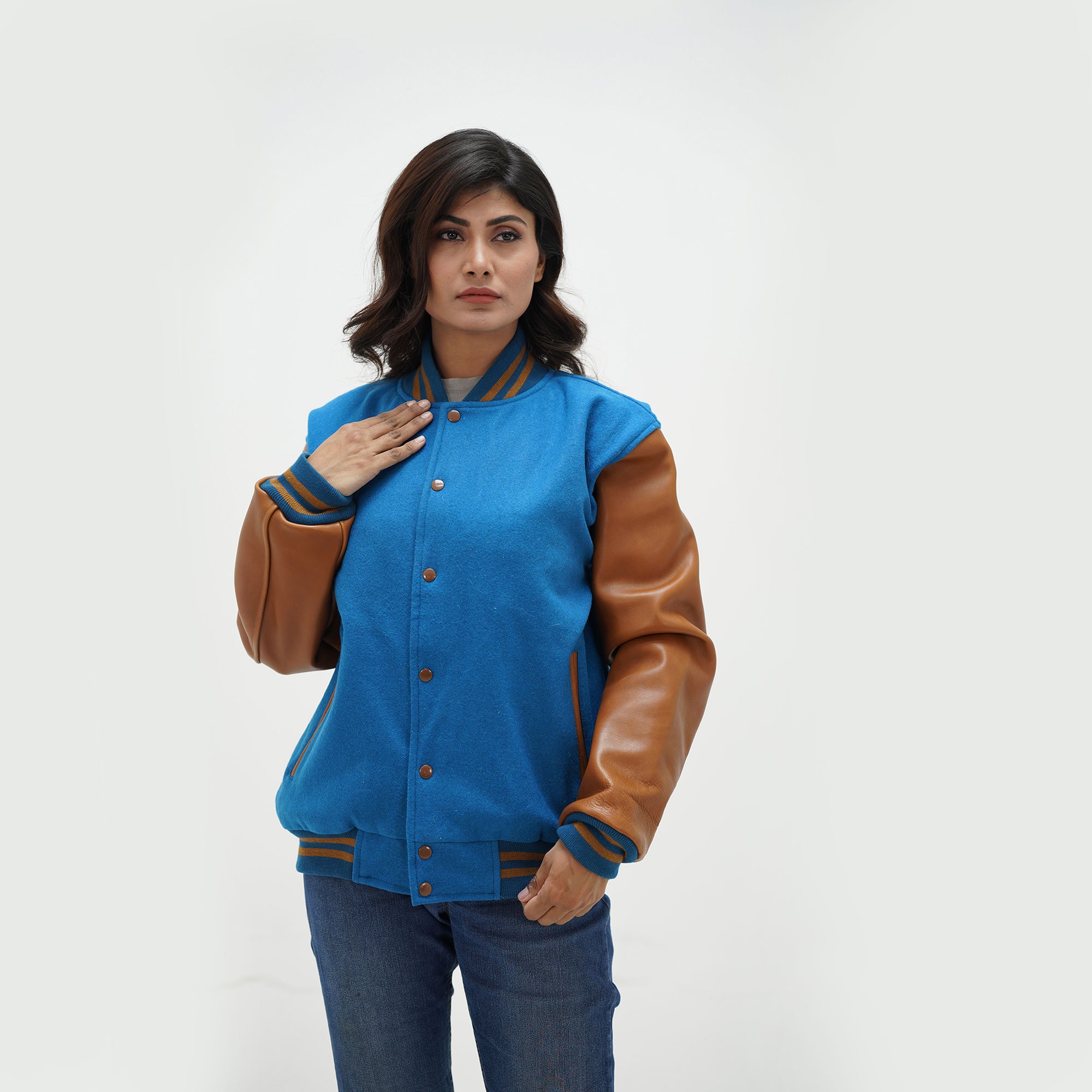 Light blue and brown letterman jacket women close-up - highlighting ribbed collar construction and snap button hardware detail