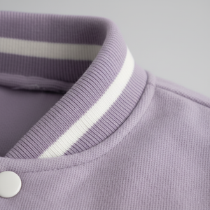 Close-up of a purple jacket with a white stripe on the collar against a light gray background