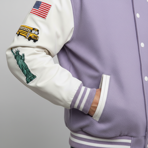 Purple varsity jacket with white sleeve featuring Statue of Liberty and school bus patches on a gray background