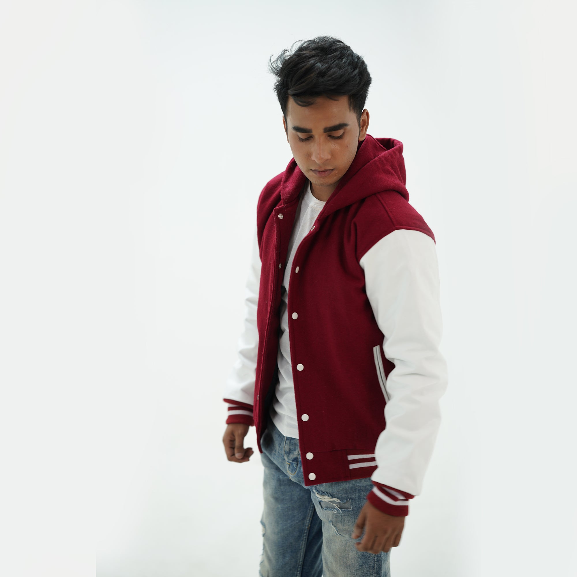 Side angle of men's magenta and white letterman hoodie highlighting genuine cowhide leather arms and premium construction