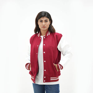 Magenta and white letterman jacket women three-quarter view - showcasing bold color contrast with white leather arms and magenta wool body