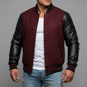 Man wearing a maroon varsity jacket with black sleeves on a gray background