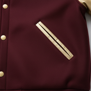 Close-up of a maroon jacket with gold buttons and a pocket detail.