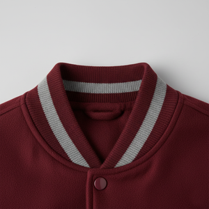 Close-up of a maroon jacket with a gray striped collar on a light gray background