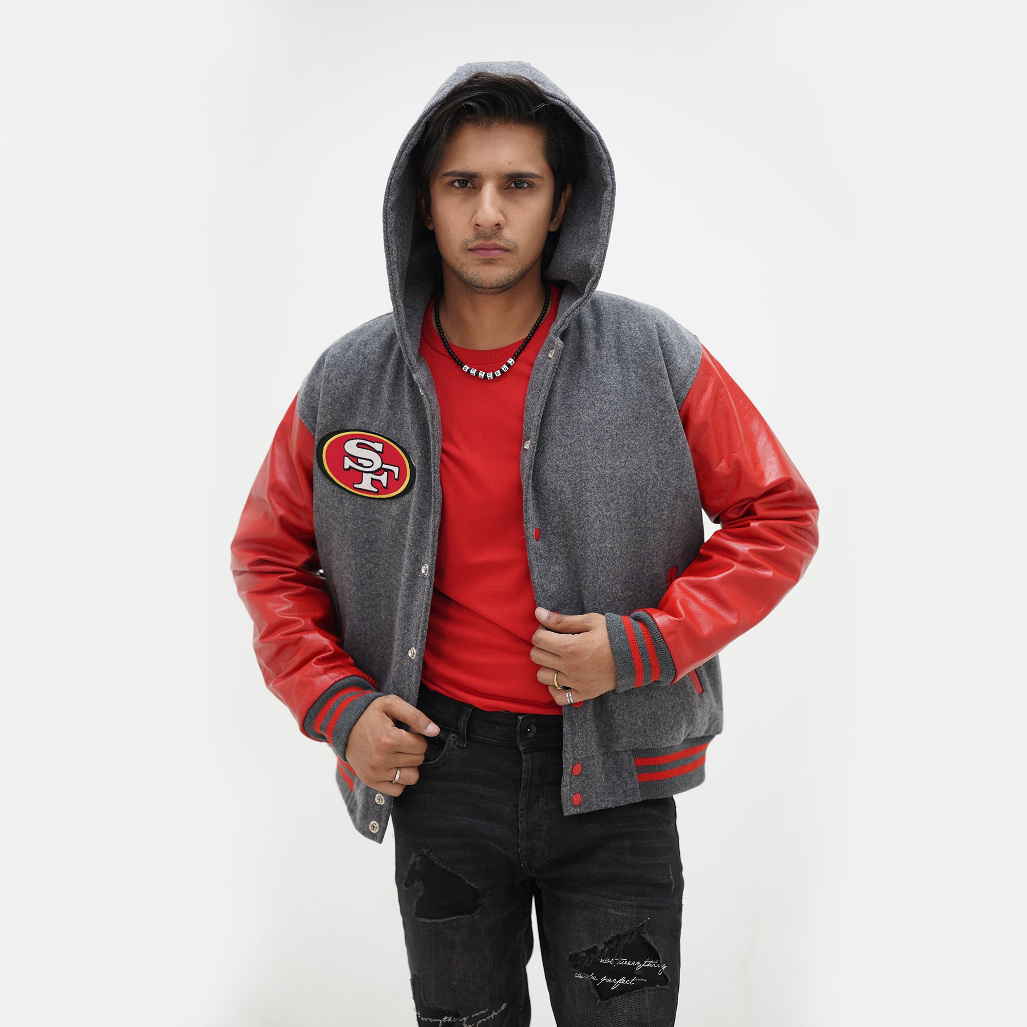 Three quarter angle of men San Francisco 49ers hooded jacket highlighting quilted interior lining and premium red leather materials