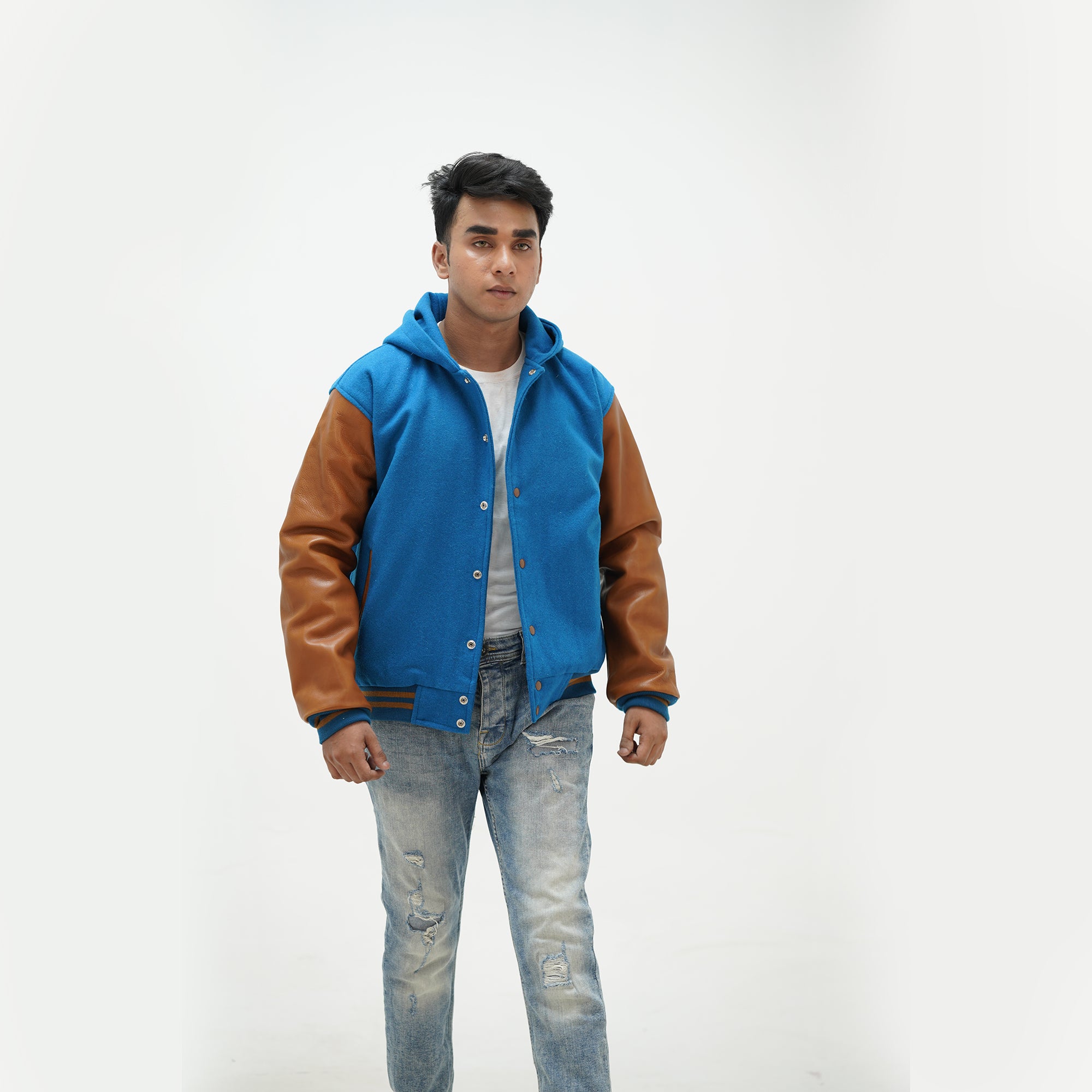 Close-up of men's sky blue varsity jacket over hoodie leather-edged side pockets and premium construction details