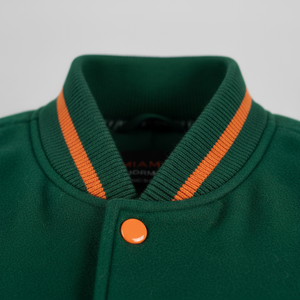 Green jacket with orange trim and button on a gray background