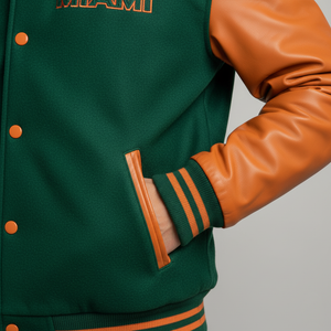 Green varsity jacket with orange accents on a gray background 