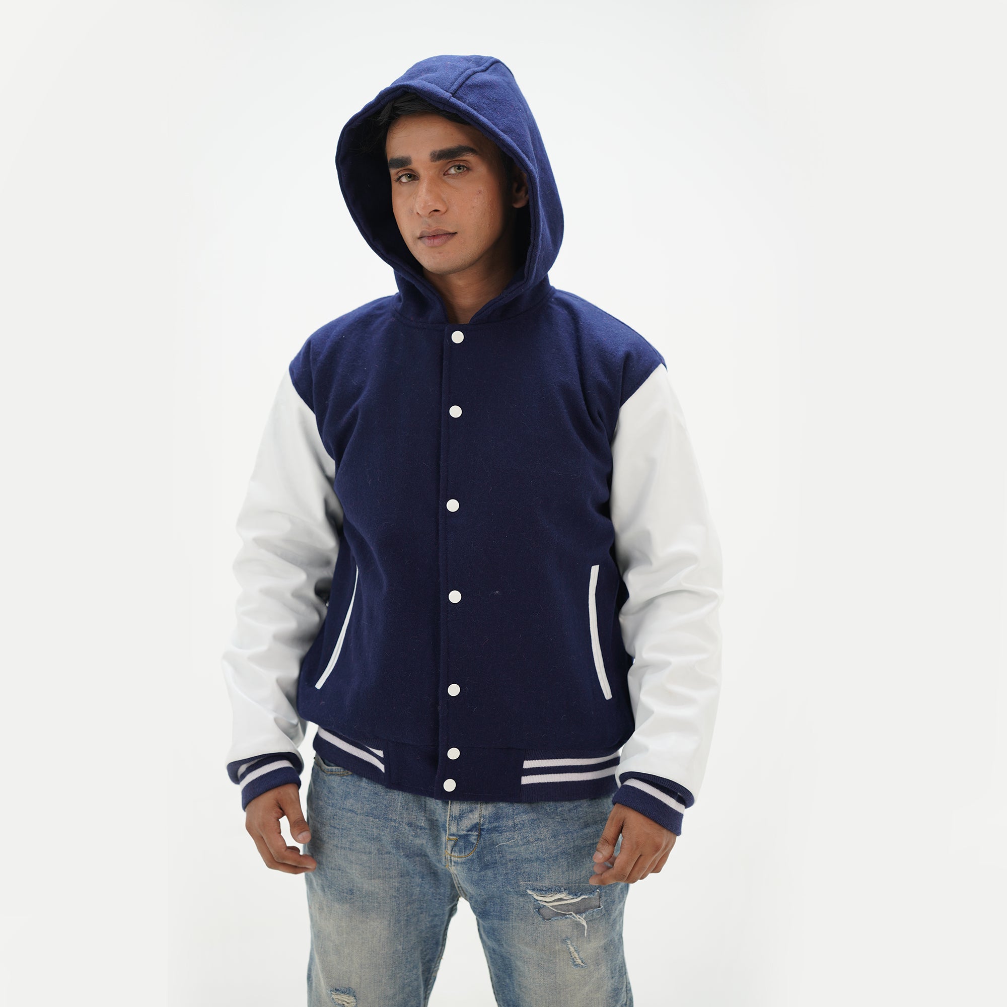 Side angle of men's navy blue hooded varsity jacket highlighting cowhide leather arms and wool body with front pouch