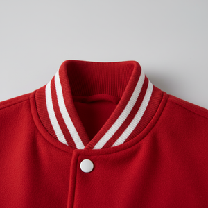 Close-up of a red jacket with white trim on a light gray background