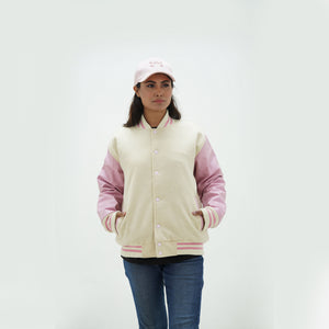 Close-up detail of off white Melton wool and pink leather sleeve connection on women's letterman jacket with ribbed collar