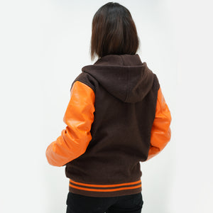 Back view of old gold women's hooded varsity jacket displaying wool body and leather sleeves with striped cuffs
