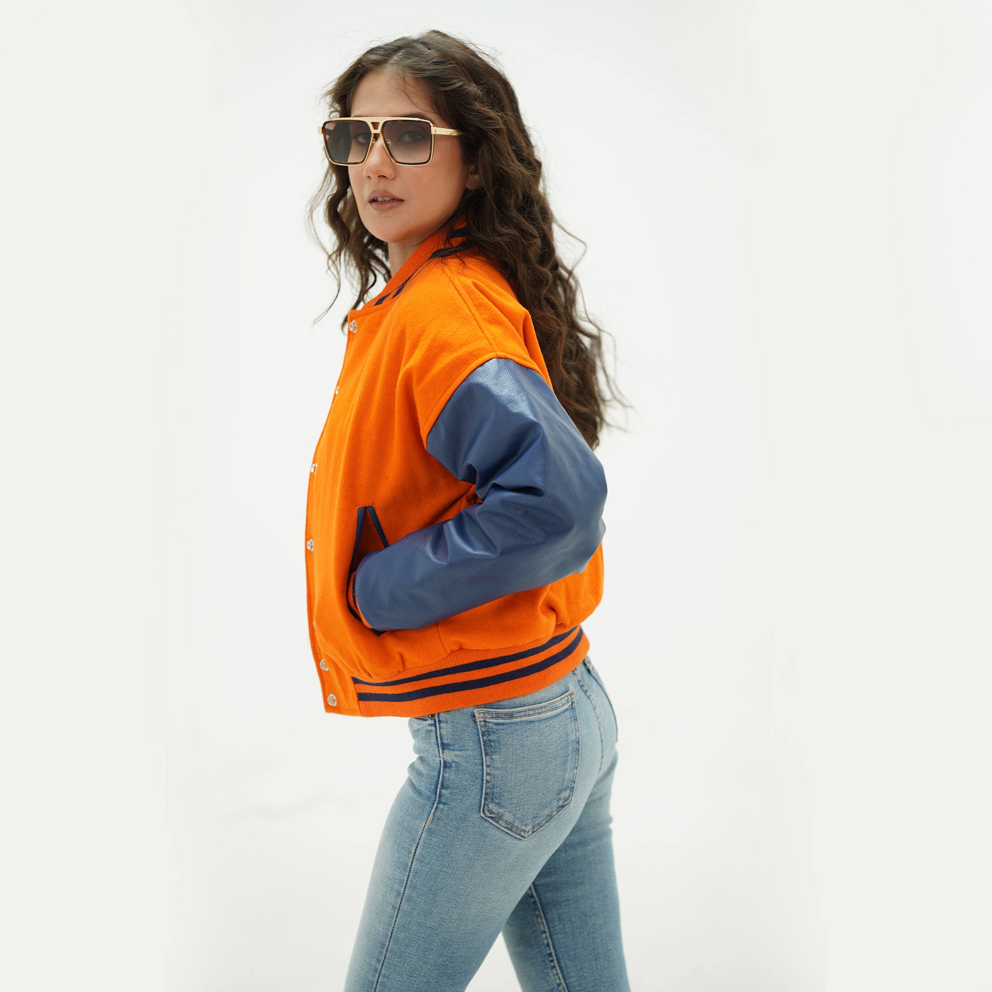 Alternate angle of orange and java plum cropped letterman jacket showcasing wool-leather construction, ribbed trim, and trendy cropped silhouette