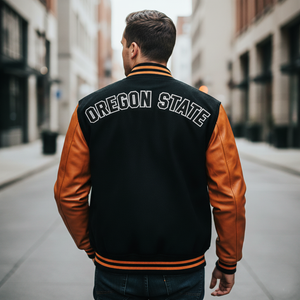 Person wearing an Oregon State varsity jacket on a city street 