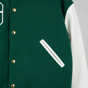 Green varsity jacket with white sleeve and gold buttons on a gray background