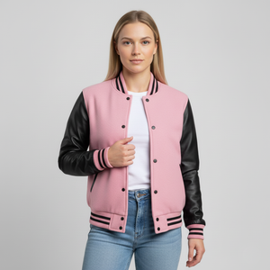 Woman wearing a pink varsity jacket with black sleeves on a gray background