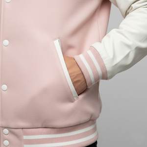 Pink varsity jacket with white accents on a neutral background
