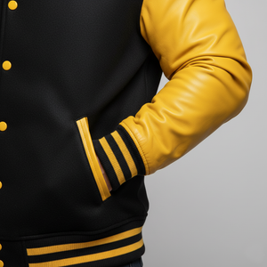 Black and yellow varsity jacket with a gray background