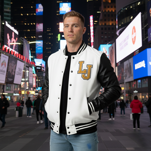 Man wearing a white letterman jacket with black sleeves and 'LJ' logo in Times Square at night.