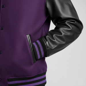 Purple varsity jacket with black leather sleeves on a gray background