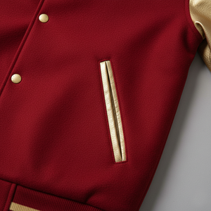 Close-up of a red jacket with gold buttons and trim on a light gray background