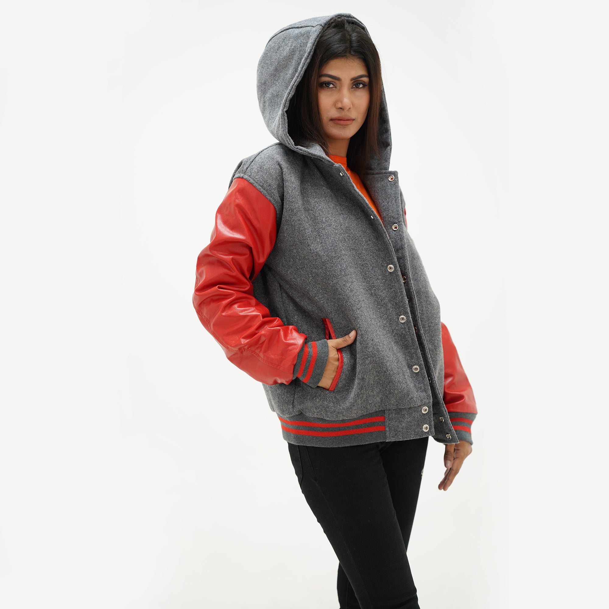 Side profile of red and gray letterman jacket featuring leather raglan sleeves and striped ribbed cuffs