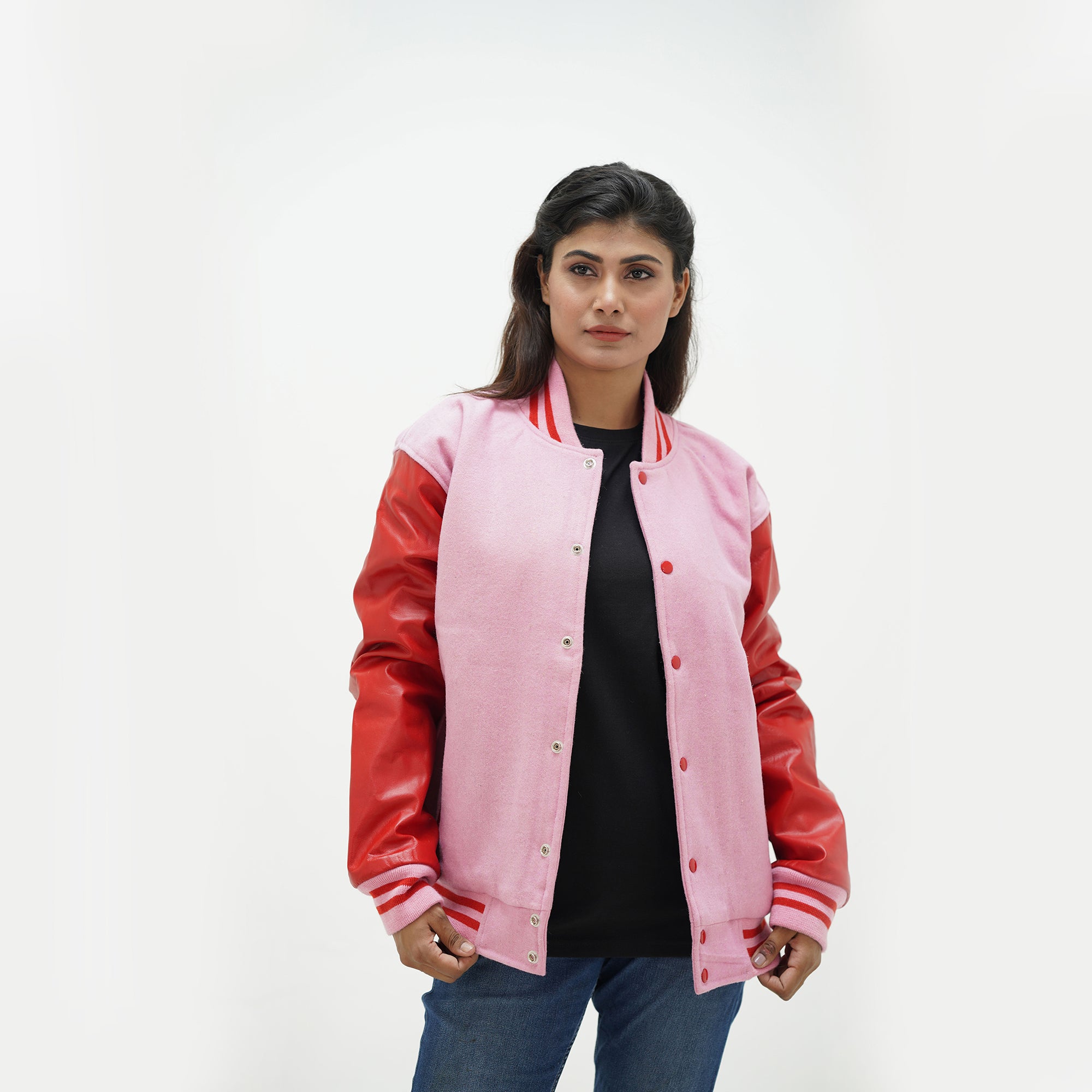 Close-up detail of red Melton wool and pink leather sleeve connection on women's varsity jacket with ribbed collar trim