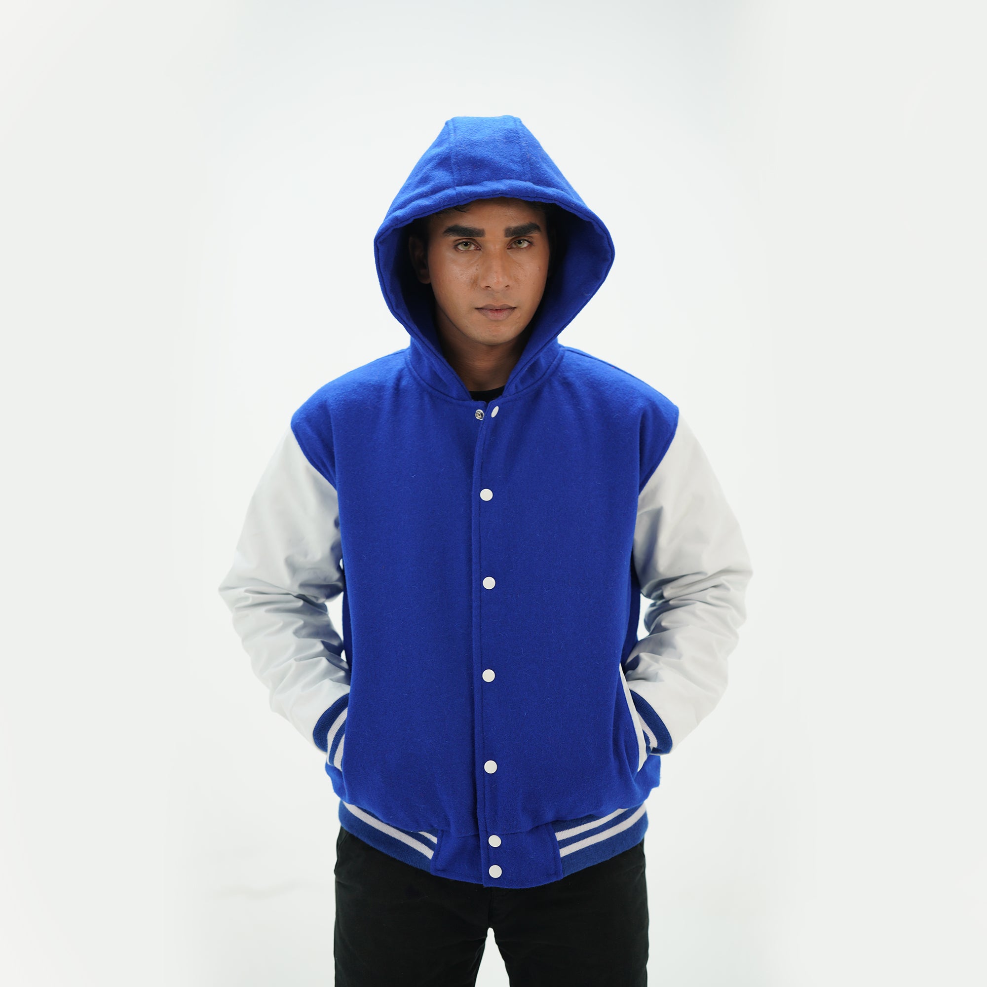 Side angle of men's royal blue hooded letterman jacket highlighting genuine cowhide white leather sleeves and cotton ribbing