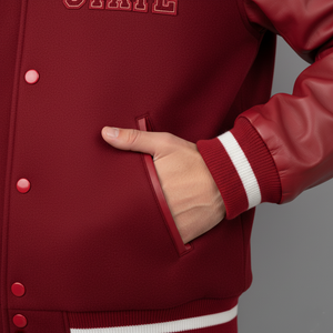 Red varsity jacket with a hand in the pocket against a gray background