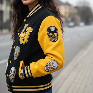 Black and yellow varsity jacket with skull designs on a blurred street background
