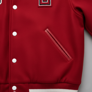 Red varsity jacket with white buttons, and pocket on a gray background
