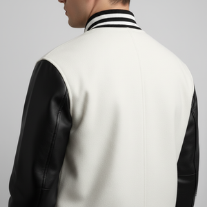 White varsity jacket with black sleeves on a gray background