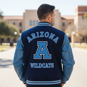Person wearing a blue and navy 'Arizona Wildcats' jacket on a college campus.