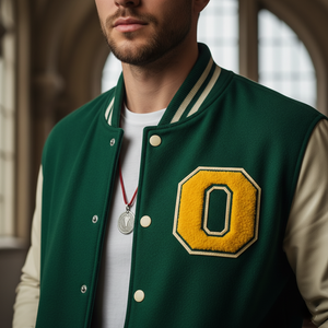 Man wearing a green letterman jacket with a yellow 'O' patch indoors.