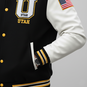 Black letterman jacket with 'UTAH' and an American flag patch, worn by a person.