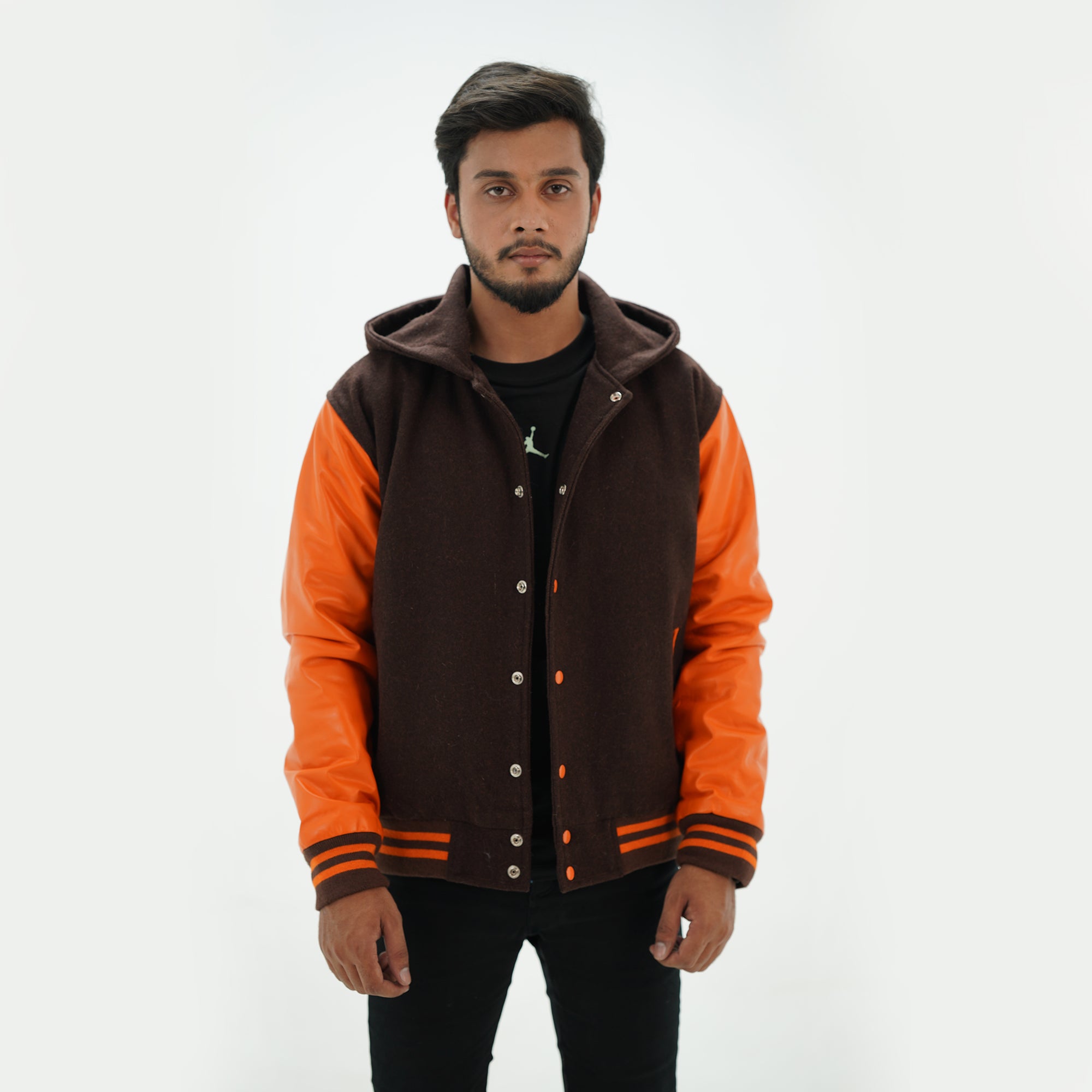 Detailed view of varsity jacket with hoodie leather arms and ribbed trim premium construction