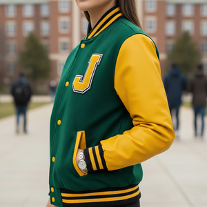 Person wearing a green and yellow varsity jacket with a large 'J' on a blurred background
