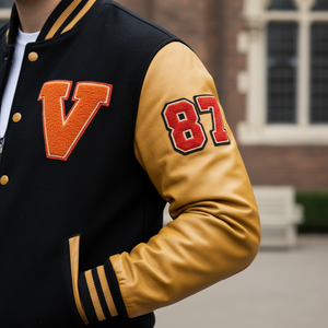 Black and yellow varsity jacket with letter 'V' and number '87' on a blurred background