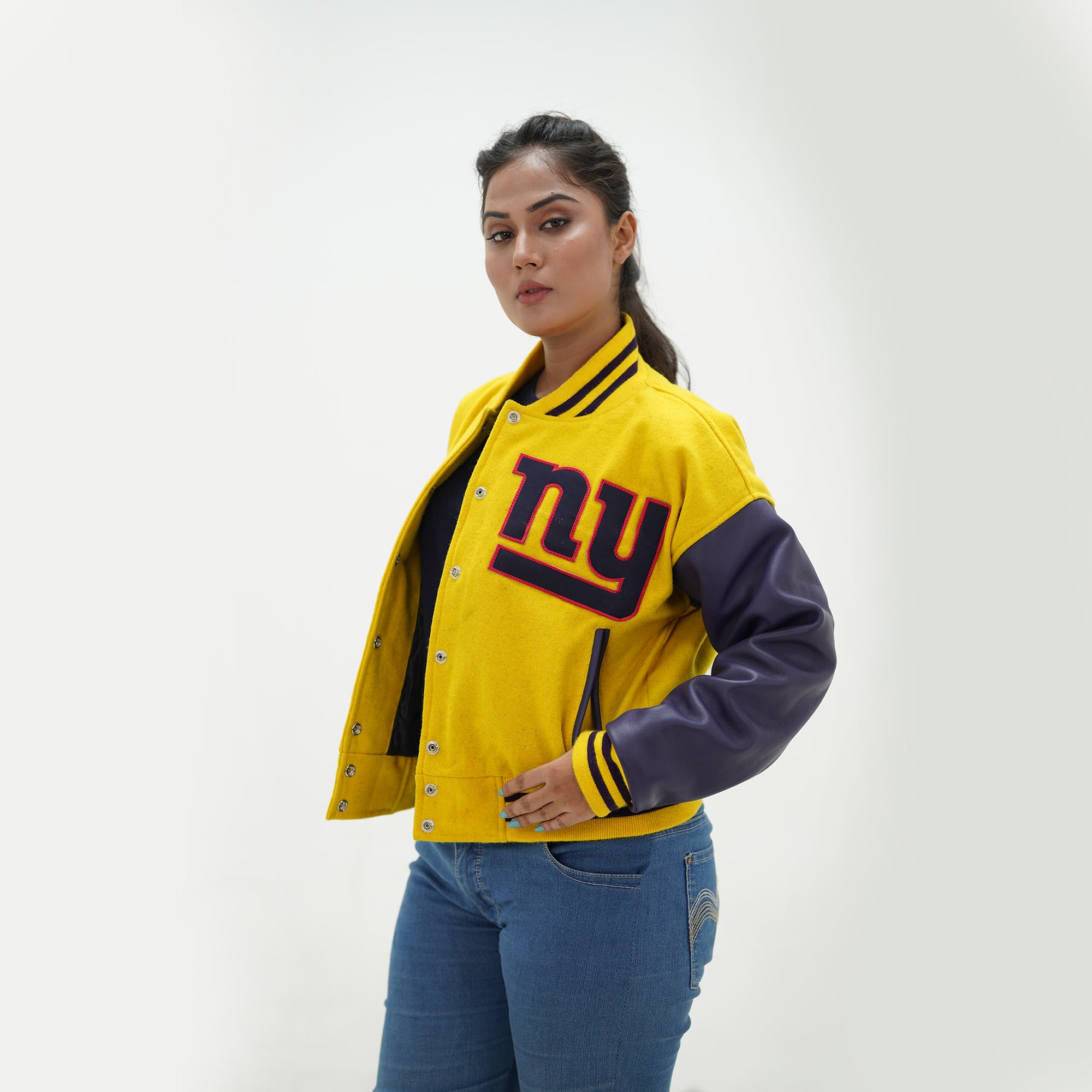 Side angle of women New York Giants letterman jacket showcasing purple leather arms and premium yellow wool body for female football fans