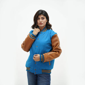 Women's blue and brown varsity jacket side angle - displaying sky blue wool body with brown leather sleeves and ribbed cuffs detail