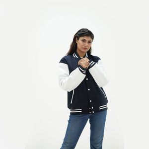 Women's dark blue varsity jacket side angle - displaying rich navy wool body with leather arms and ribbed cuffs detail