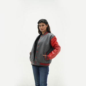 Side angle of women's grey wool letterman jacket with red leather sleeves displaying ribbed cuffs and tailored feminine fit
