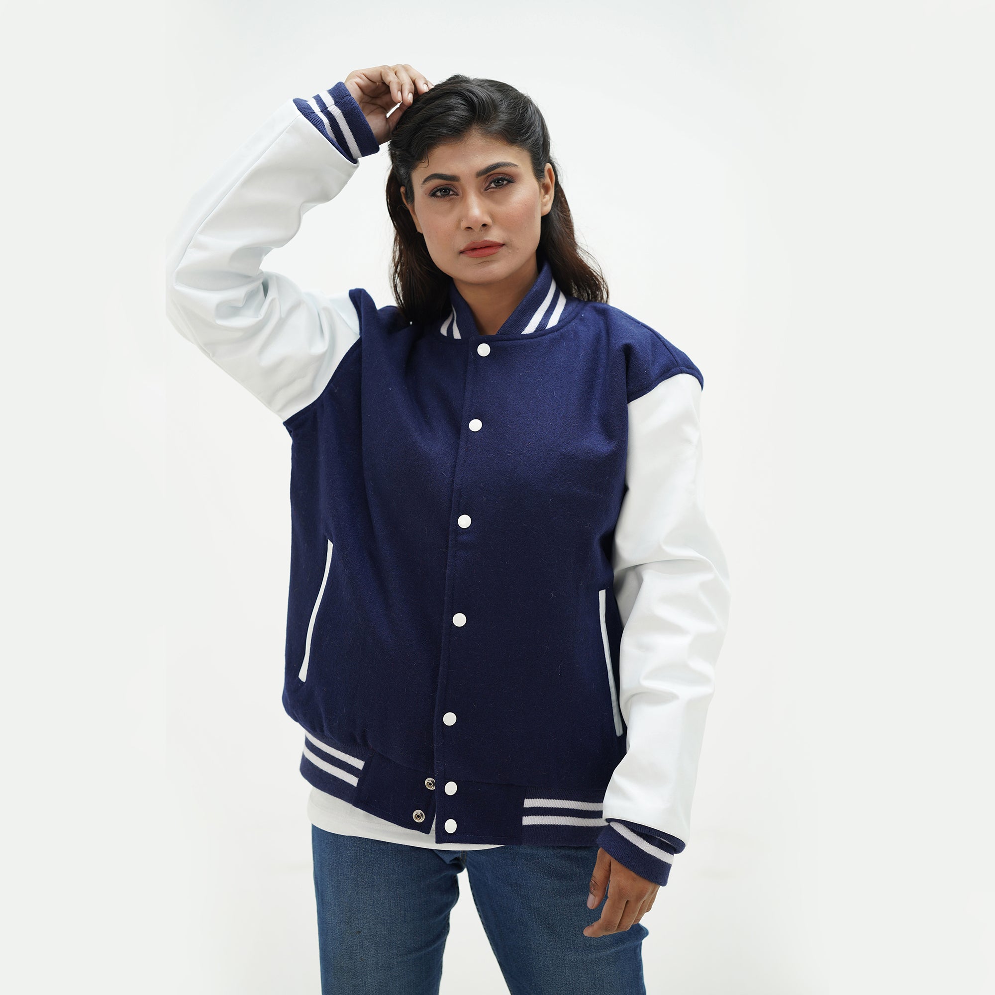 Women's navy varsity jacket three-quarter view - highlighting feminine tailored fit with leather sleeves and navy blue wool body