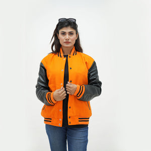 Full display of women's orange and black letterman jacket showing complete silhouette, ribbed hem, and eye-catching color combination